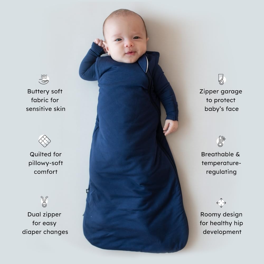 Kyte Baby navy sleep bag top-closure reduces facial scratches during night checks.