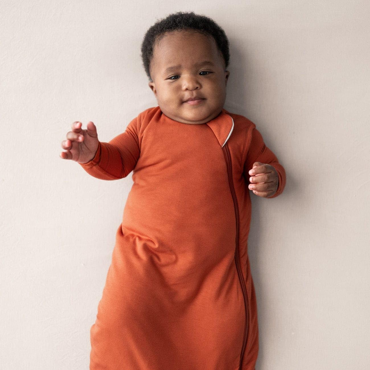 Kyte Baby sleep bag rust with J-shaped zipper enabling quick, safe nighttime changes.