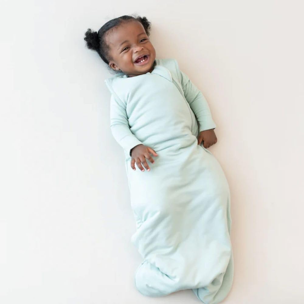 KYTE BABY sleep bag sage zipper close-up shows easy night-time diaper changes.