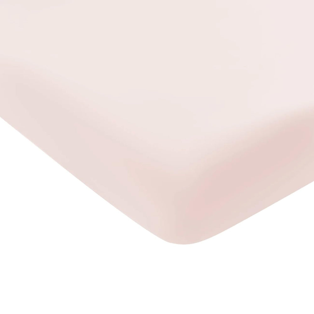Kyte Baby Soft Crib Sheet blush on crib mattress shows soft, breathable fabric in blush