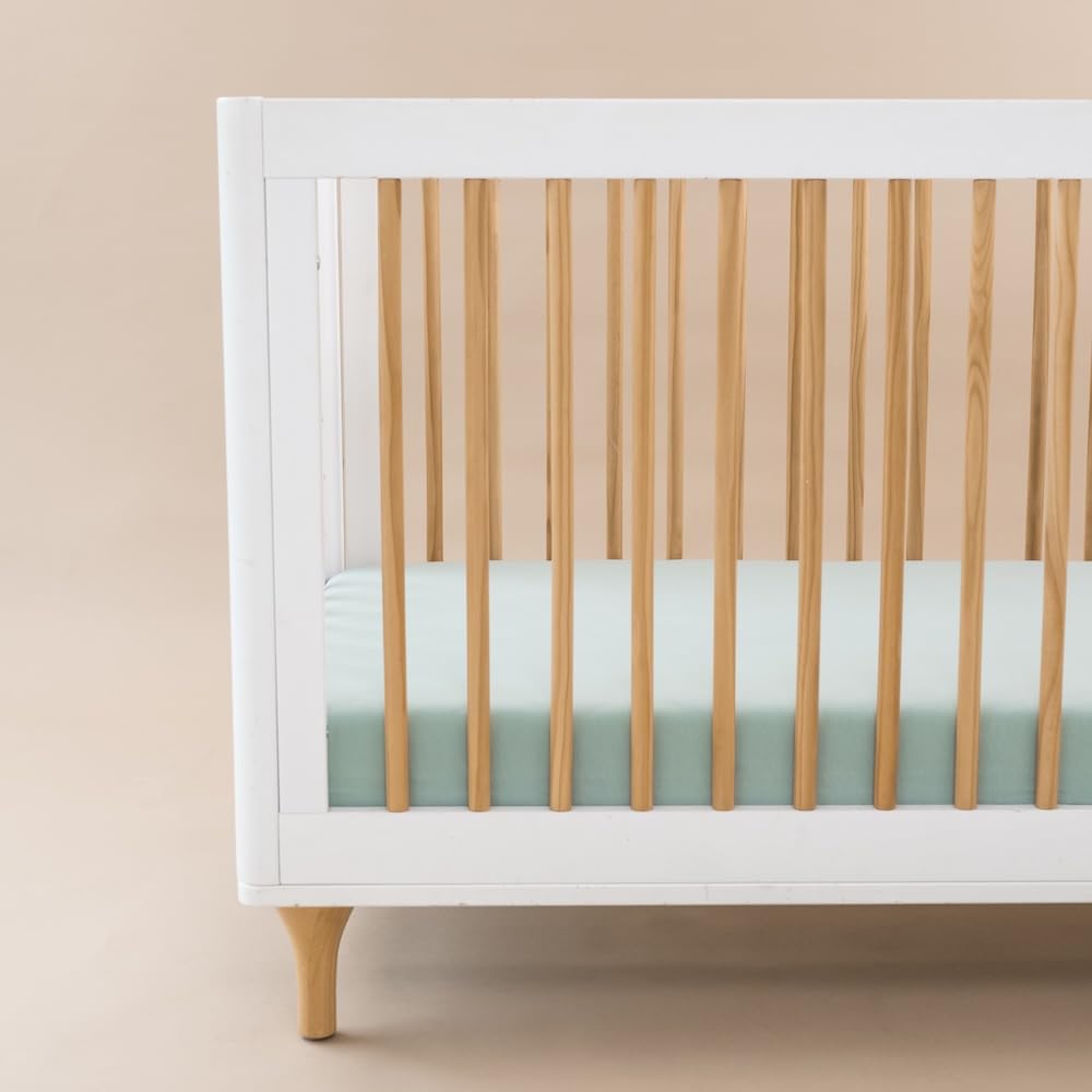 Kyte Baby sage crib sheet elastic edge demonstrates easy, secure crib fit