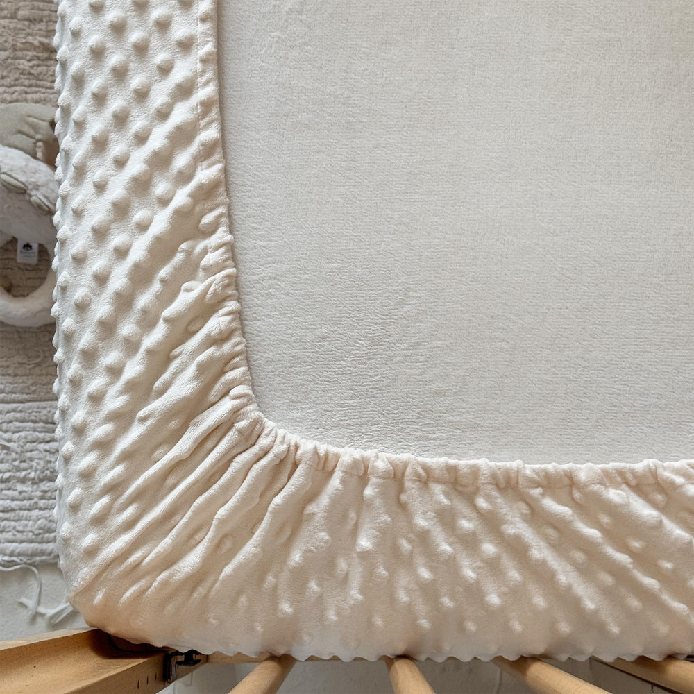 La Sheer green crib sheet offers vibrant, easy-to-match color for nursery decor.