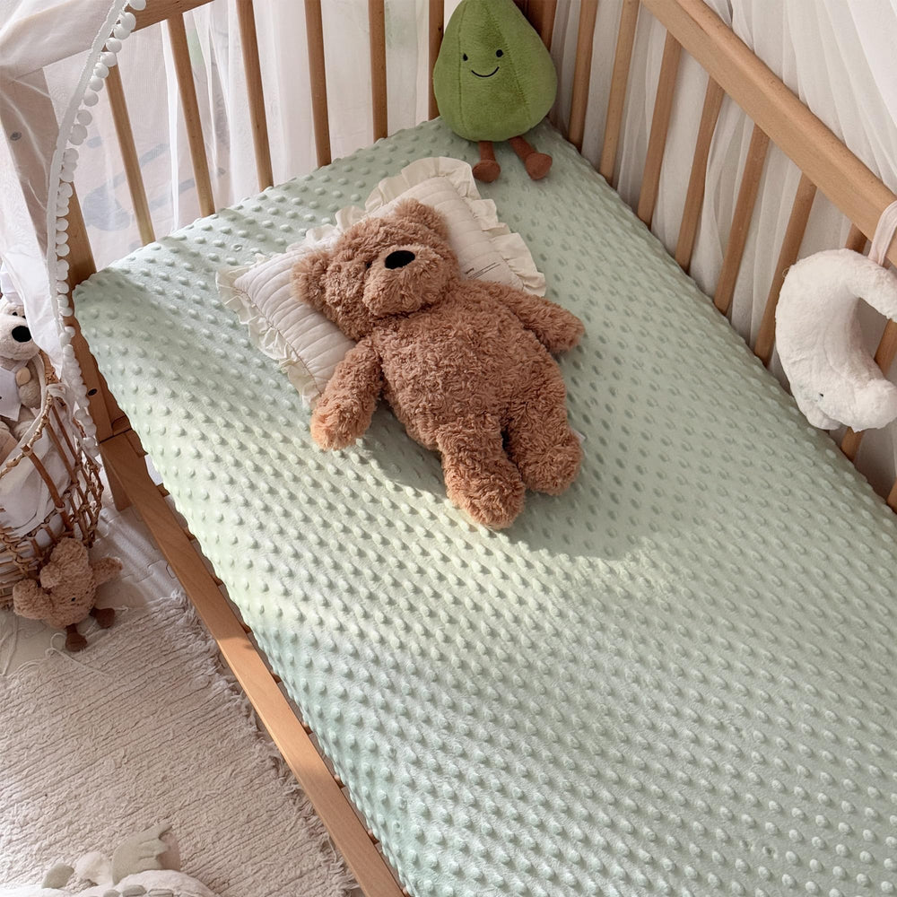 La Sheer light beige crib sheet adds cozy, gender-neutral tone to nursery.