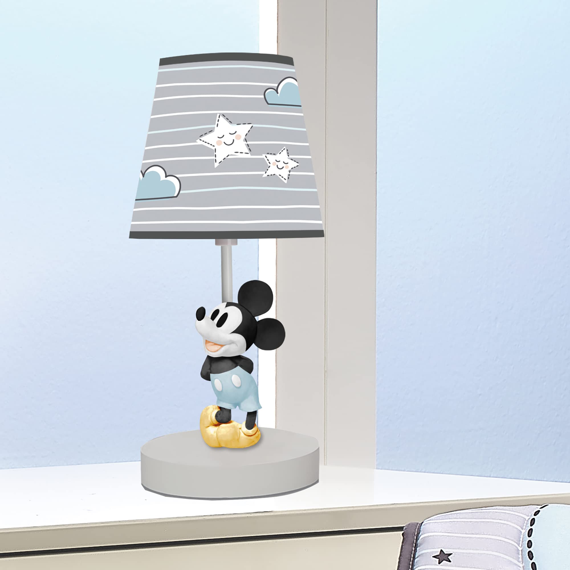 Lambs & Ivy gray and white lamp shade coordinates with nursery decor for a calming look.