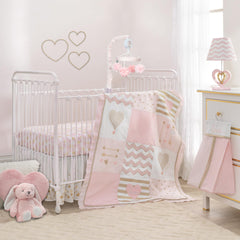 Lambs & Ivy Baby Love pink-gold comforter enhances cozy crib time.