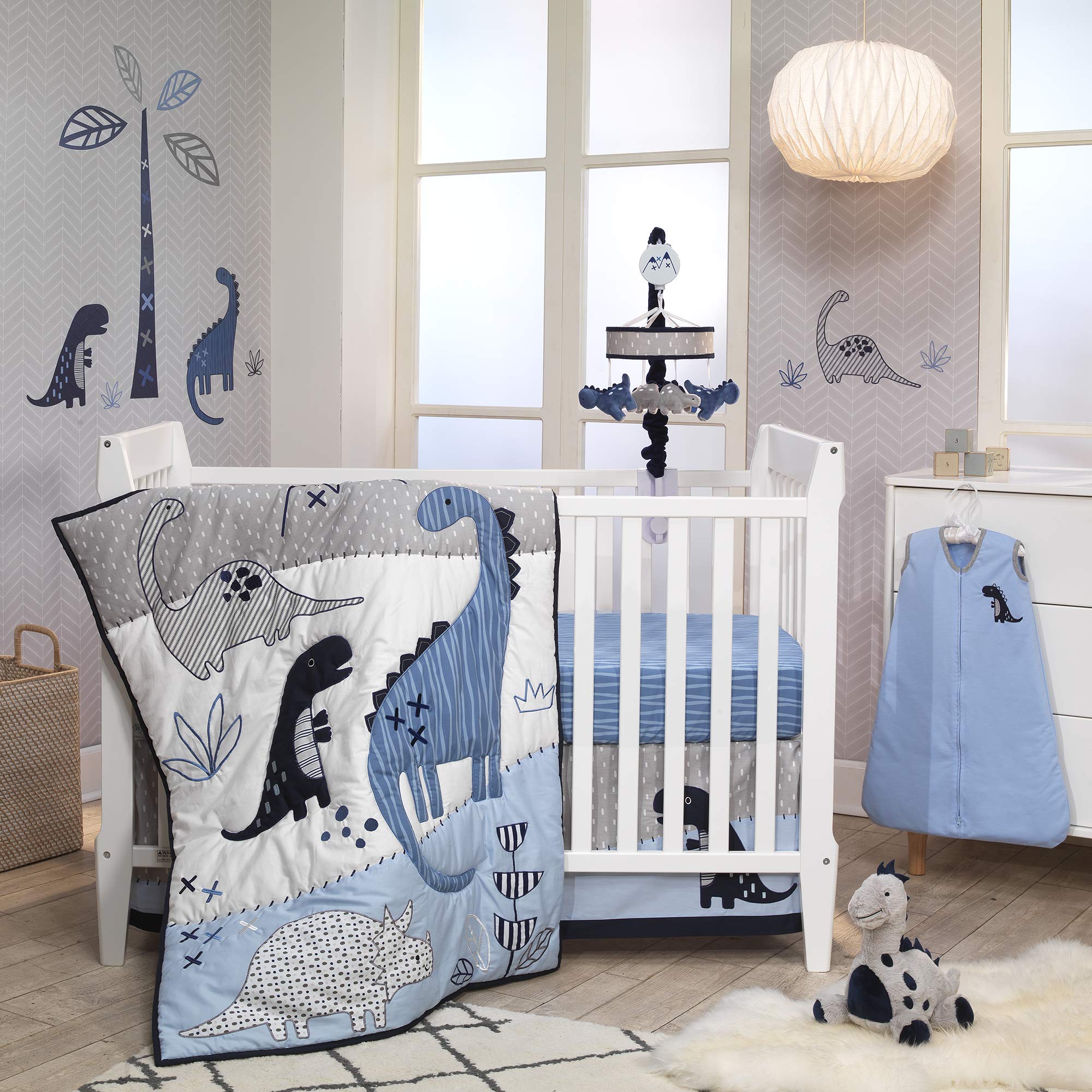 Lambs & Ivy dino mobile in nursery setting ready to entertain and soothe baby