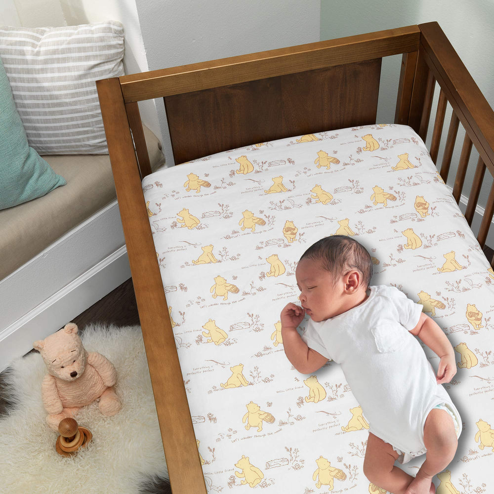 Lambs & Ivy Pooh Storytime crib skirt with 14-inch drop for a polished nursery base.