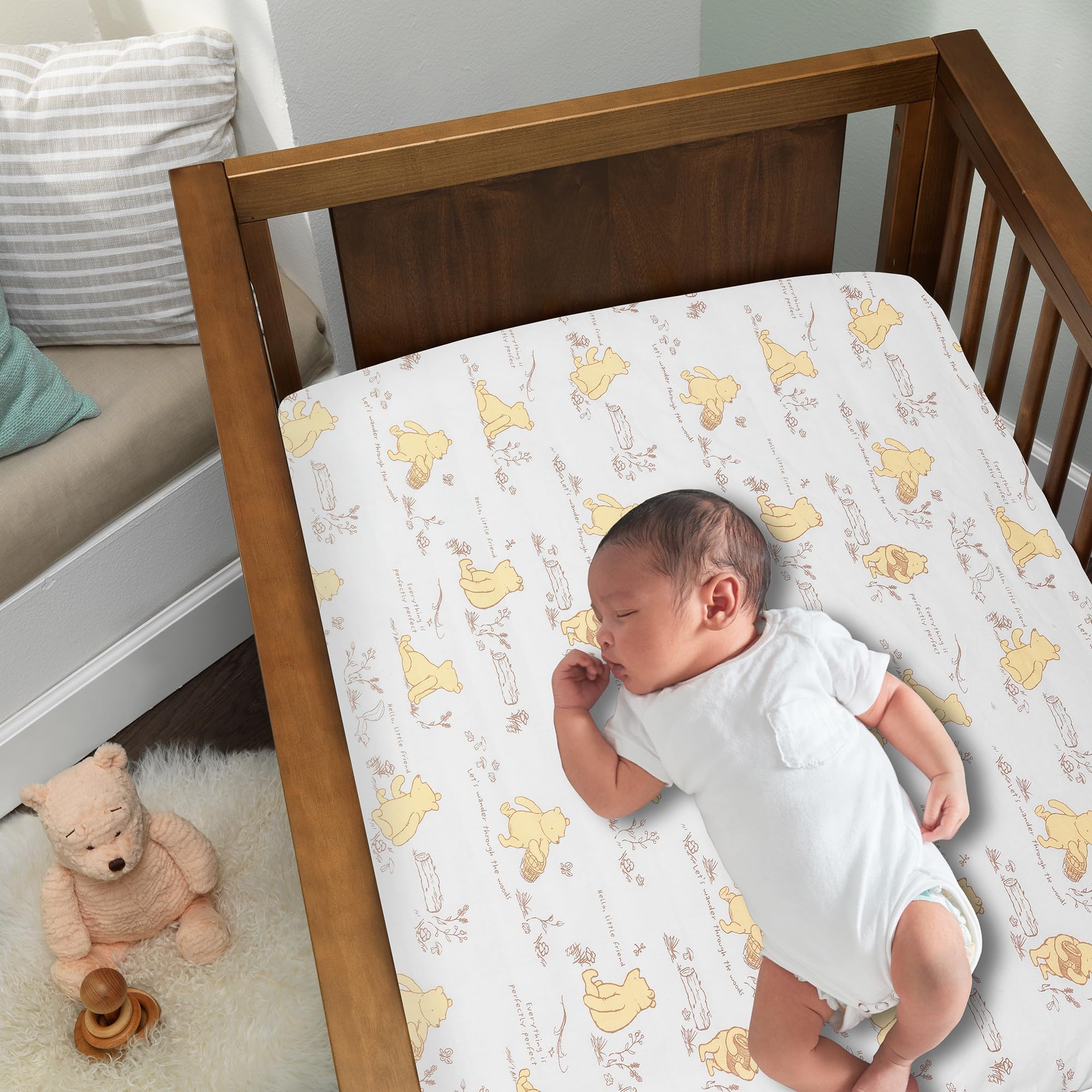 Lambs & Ivy Disney Baby Storytime Pooh sheet closeup shows soft cotton weave for gentle sleep.