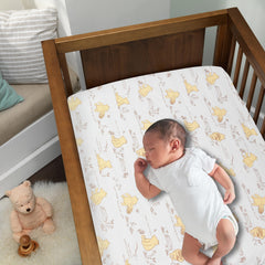 Lambs & Ivy Disney Baby Storytime Pooh sheet closeup shows soft cotton weave for gentle sleep.