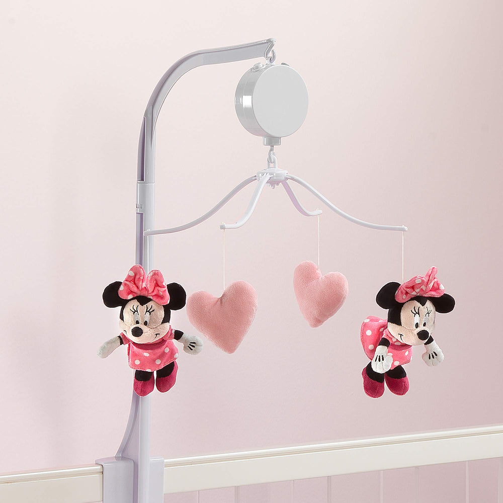 Lambs & Ivy Minnie mobile spinning softly in a calm nursery setting.