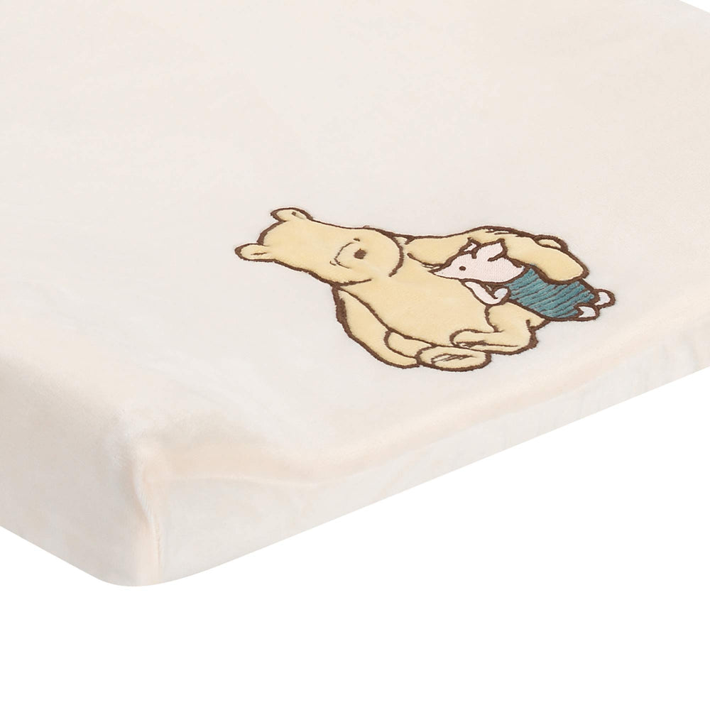 Lambs & Ivy Storytime Pooh minky fabric close-up emphasizes soft warmth for diaper changes.