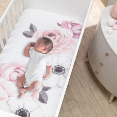 Lambs & Ivy Floral Garden elastic around fit secures standard 52x28 crib mattress.