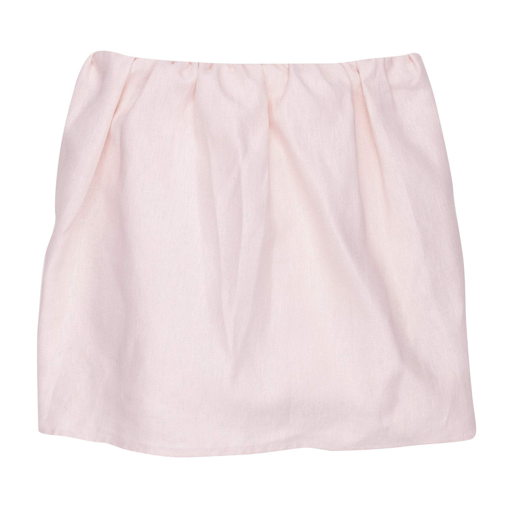Lambs & Ivy Floral Garden pink linen crib skirt around crib posts for tidy framing.