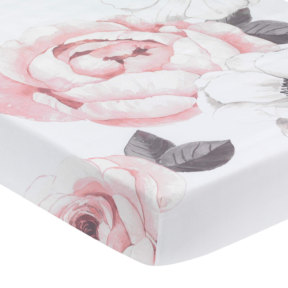 Lambs & Ivy Floral Garden pink watercolor crib sheet showcases soft cotton for cozy naps.