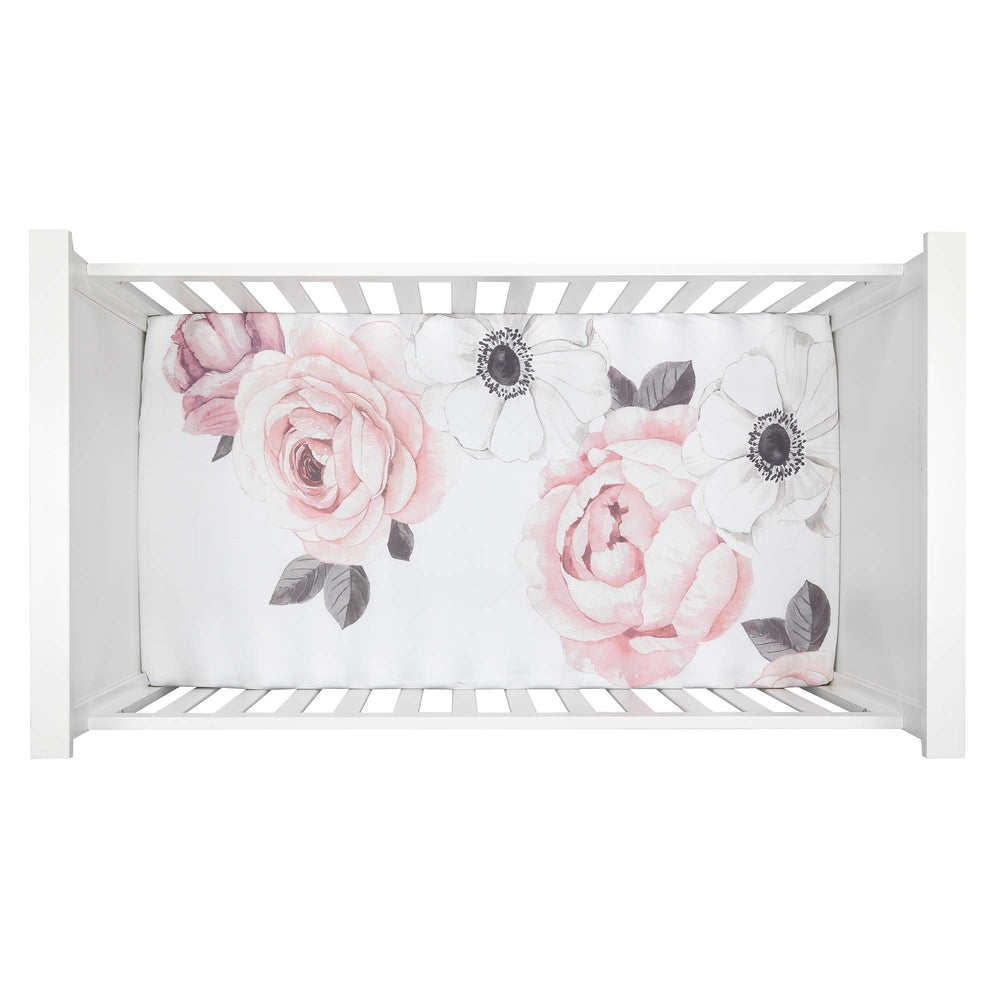 Lambs & Ivy Floral Garden watercolor flowers detail promotes a gentle, stylish crib backdrop.