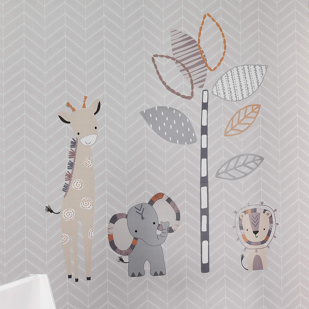 Lambs and Ivy Jungle Safari giraffe wall decal creates a tall friendly focal point in a nursery