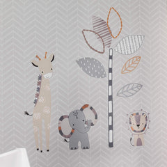 Lambs and Ivy Jungle Safari giraffe wall decal creates a tall friendly focal point in a nursery