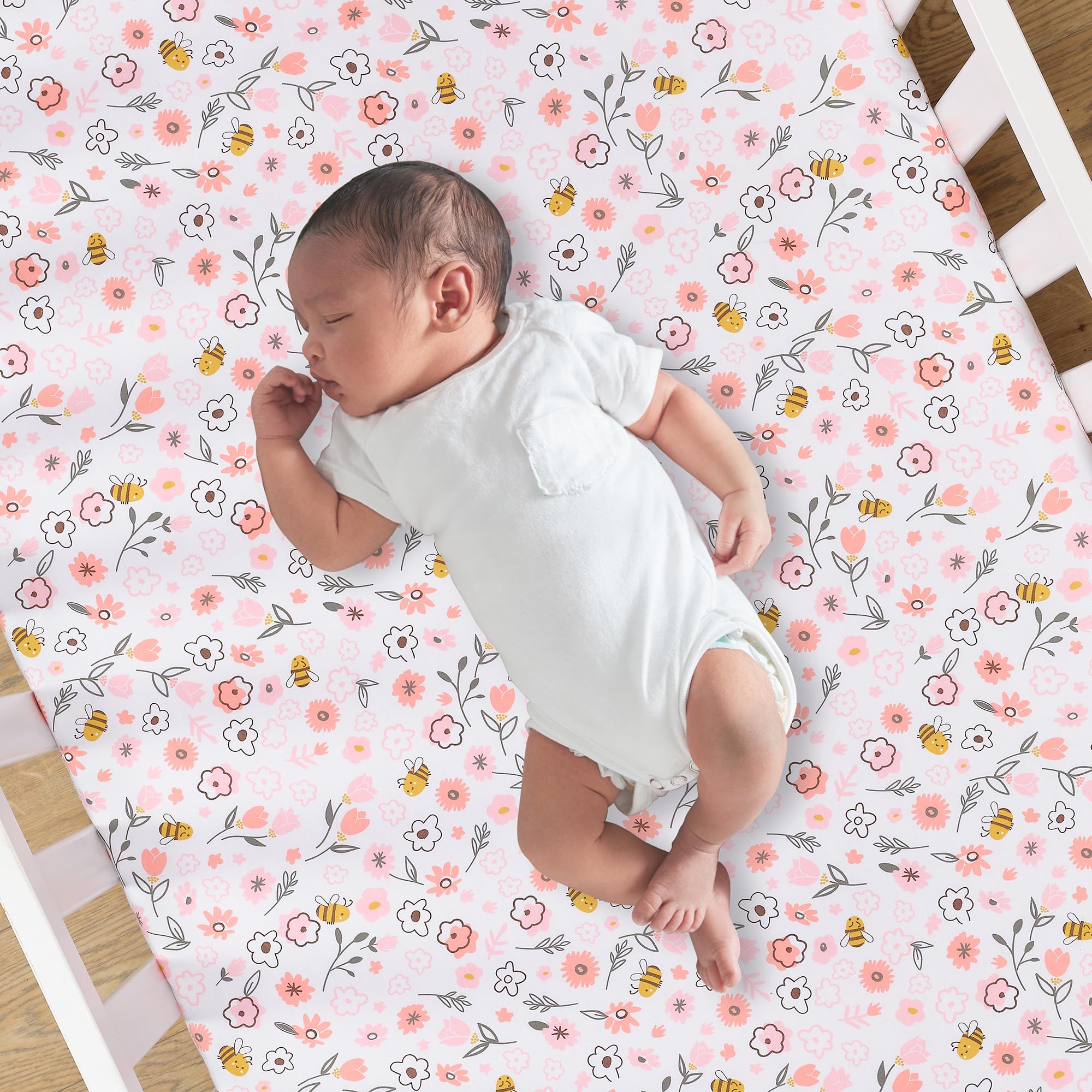 Lambs and Ivy Little Garden Sheet on mattress, secure elastic all around for a snug crib fit.