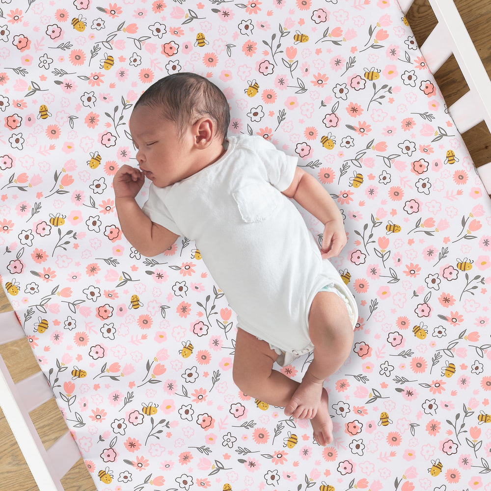 Lambs and Ivy Little Garden Sheet on mattress, secure elastic all around for a snug crib fit.