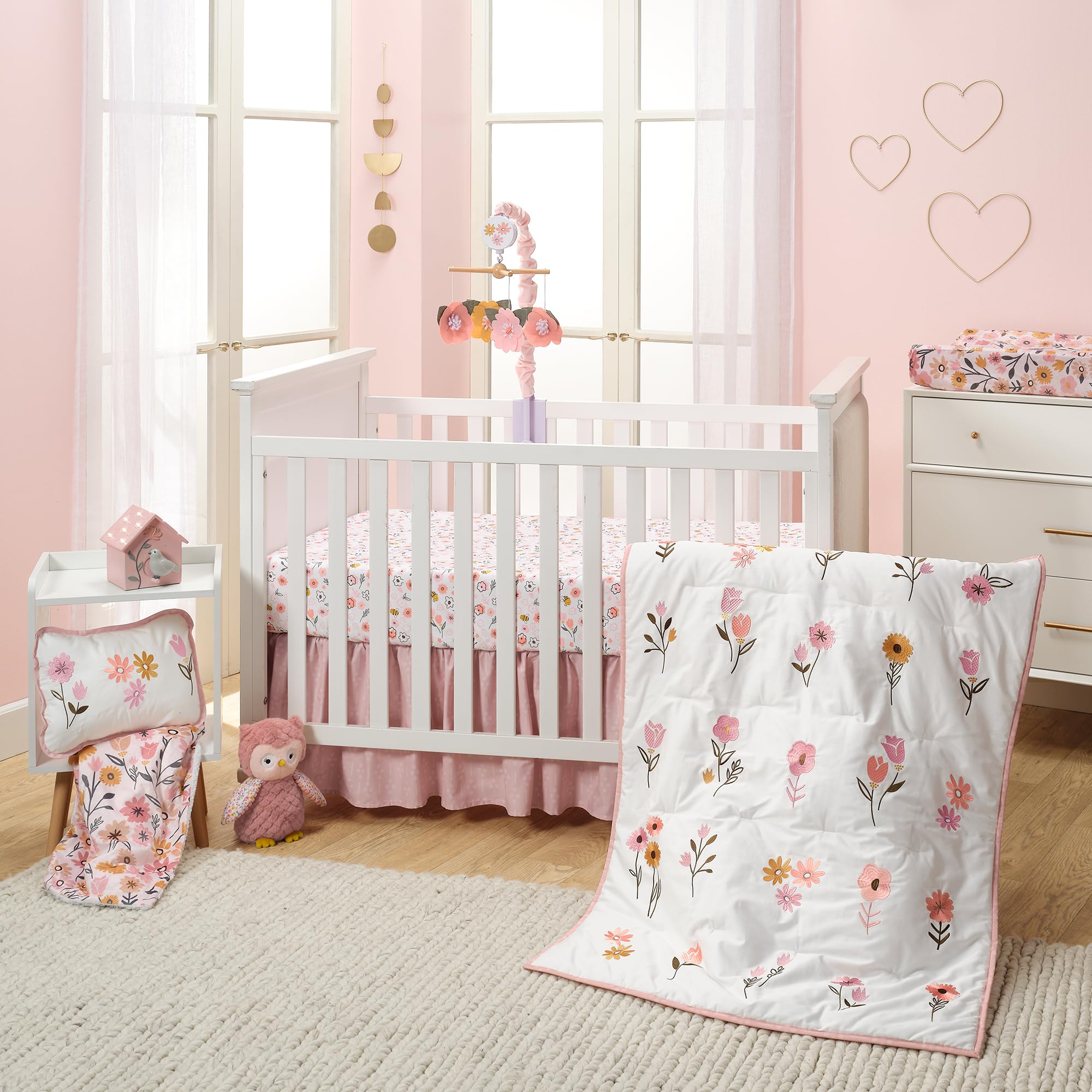Lambs and Ivy Little Garden Sheet on toddler bed, pastel floral design adds gentle room charm.