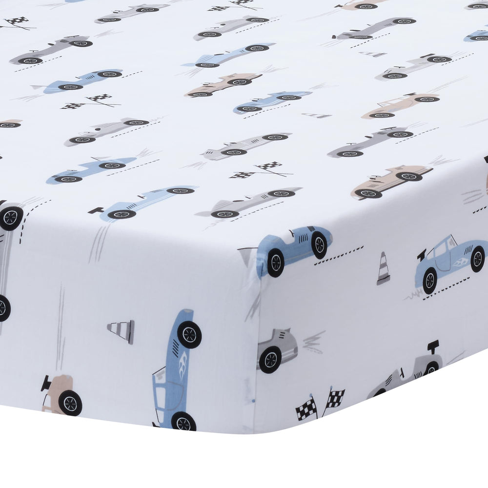 Lambs & Ivy Little Racer crib skirt with colored race cars elevates nursery decor.