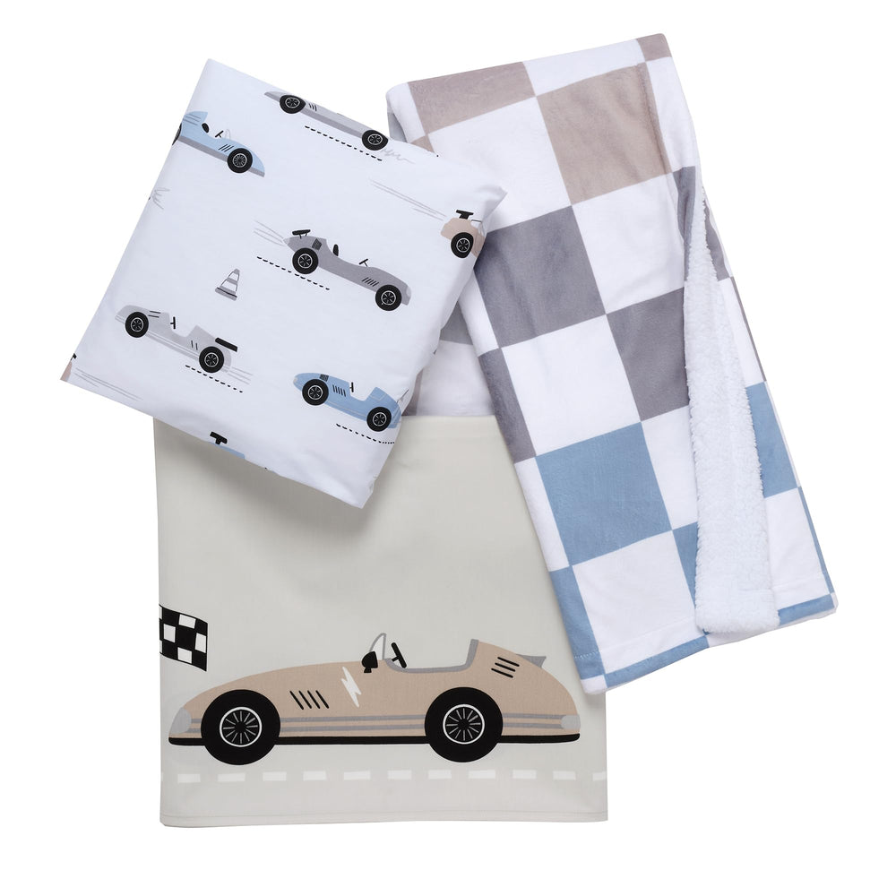 Lambs & Ivy Little Racer nursery scene demonstrates cohesive crib styling.