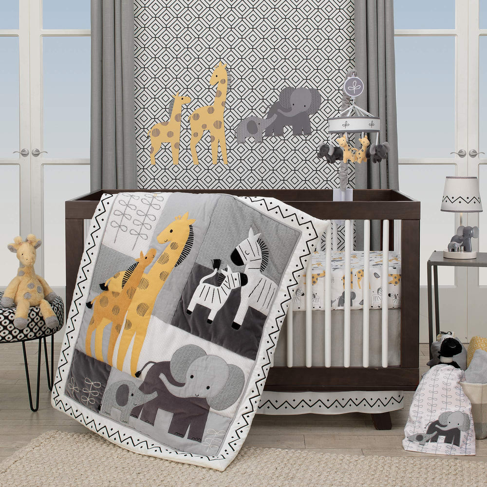 Lambs & Ivy Me & Mama elephant lamp placed in a coordinated nursery scene