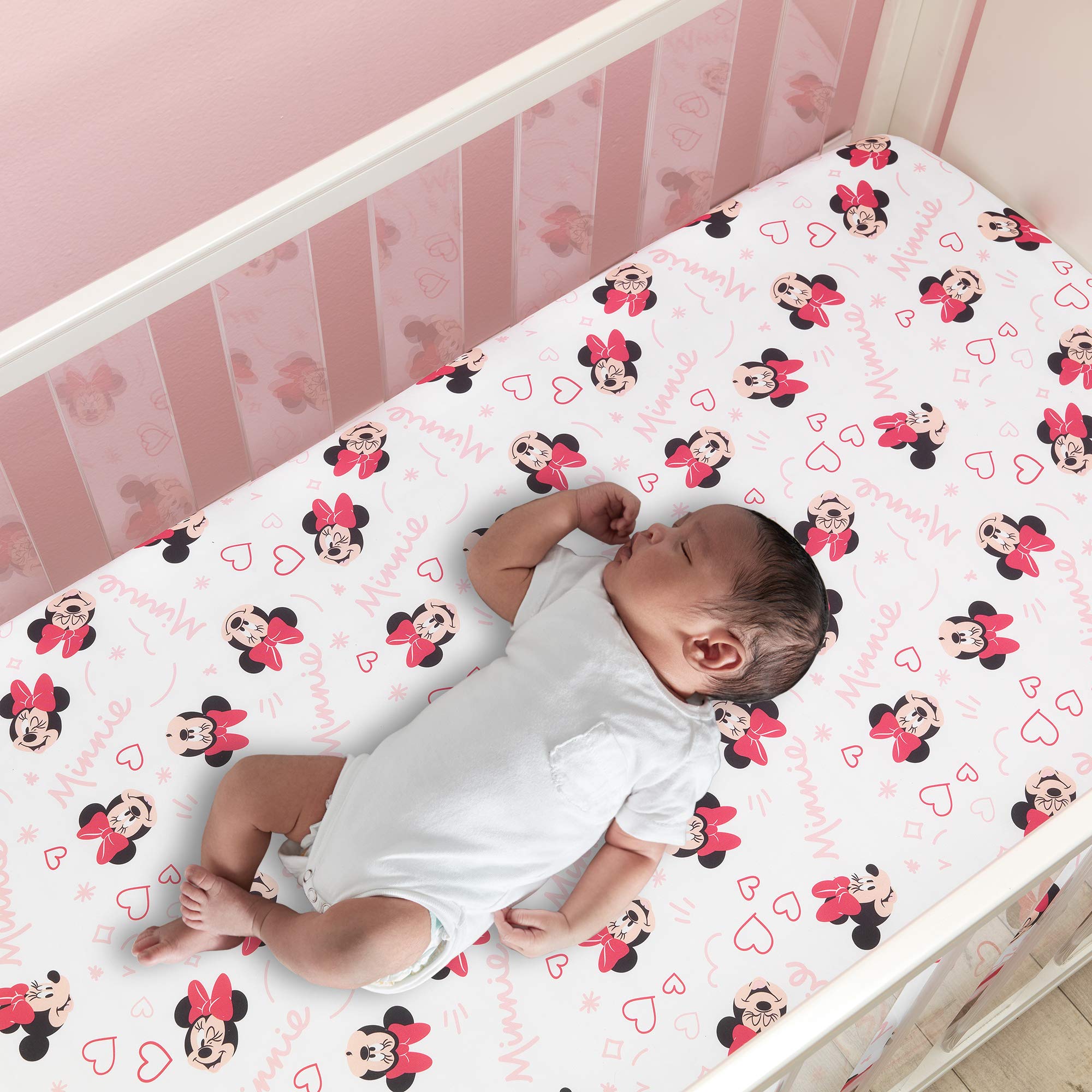 Lambs & Ivy Minnie Love crib sheet white background with pink hearts and Minnie heads.