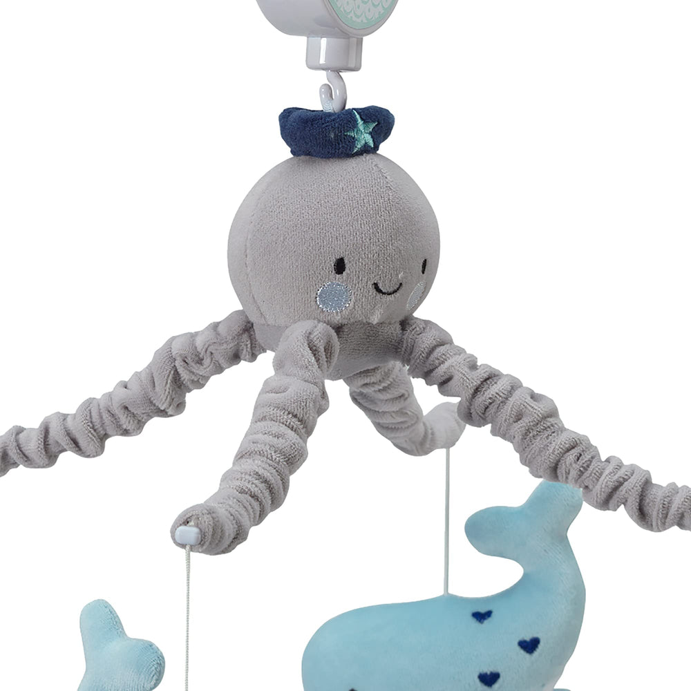 Lambs & Ivy Oceania mobile whales whirl for engaging visual lullaby.