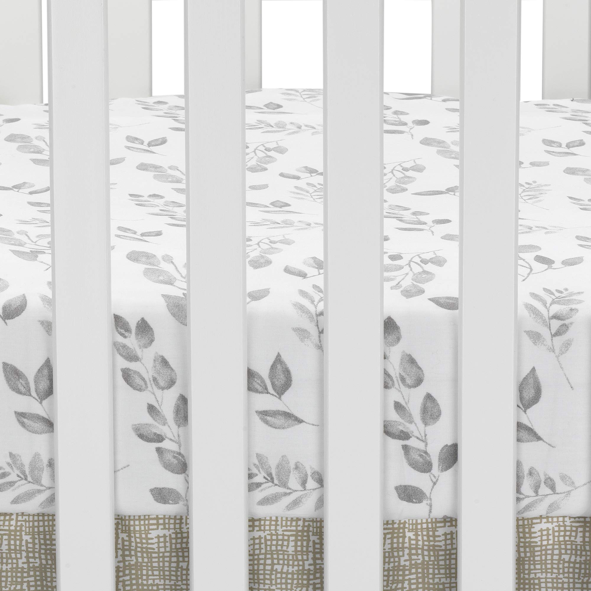 Close-up of elastic edge on Lambs & Ivy Painted Forest crib sheet for a secure fit.