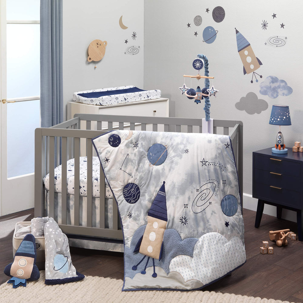 Lambs & Ivy Sky Rocket quilt with space appliques for cozy nursery decor.