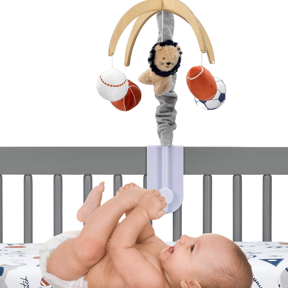 Lambs & Ivy sports balls plush toys engage baby during playtime.