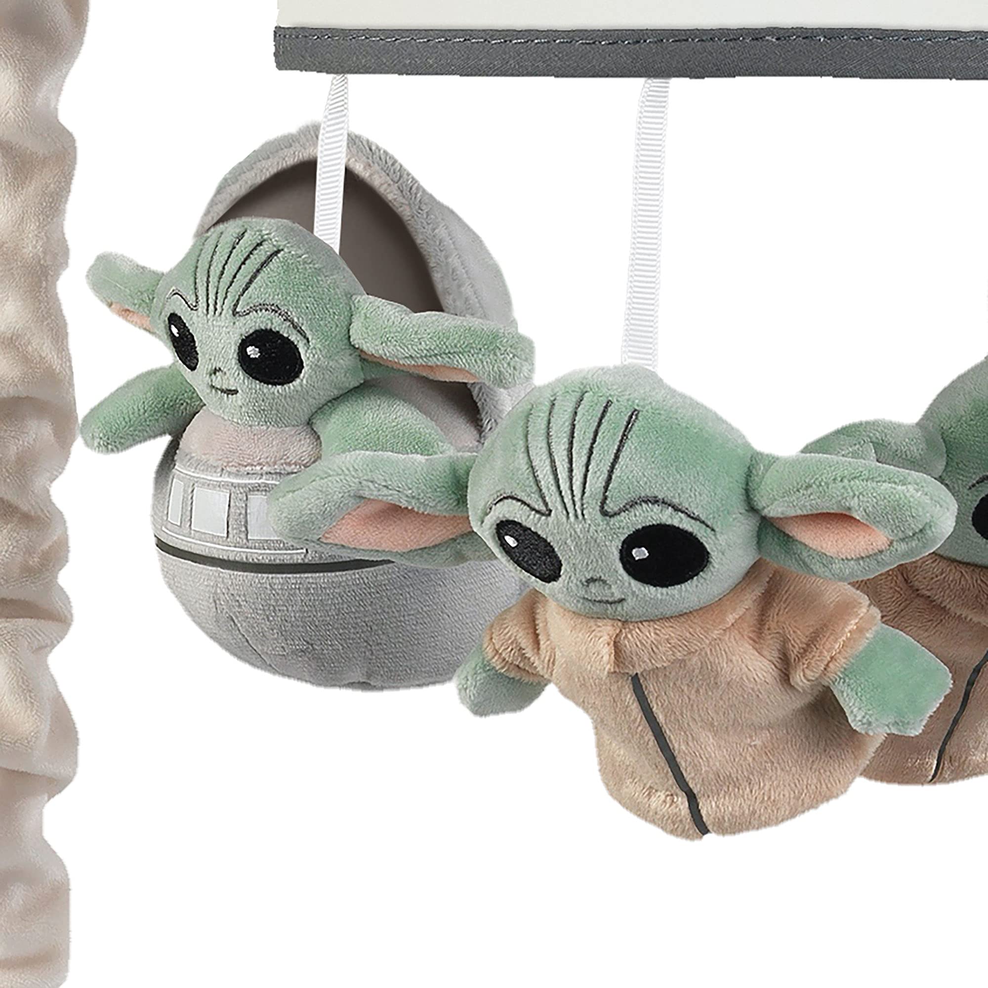 Lambs & Ivy Star Wars mobile spinning gently, guiding visual tracking and calm moments.