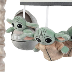 Lambs & Ivy Star Wars mobile spinning gently, guiding visual tracking and calm moments.