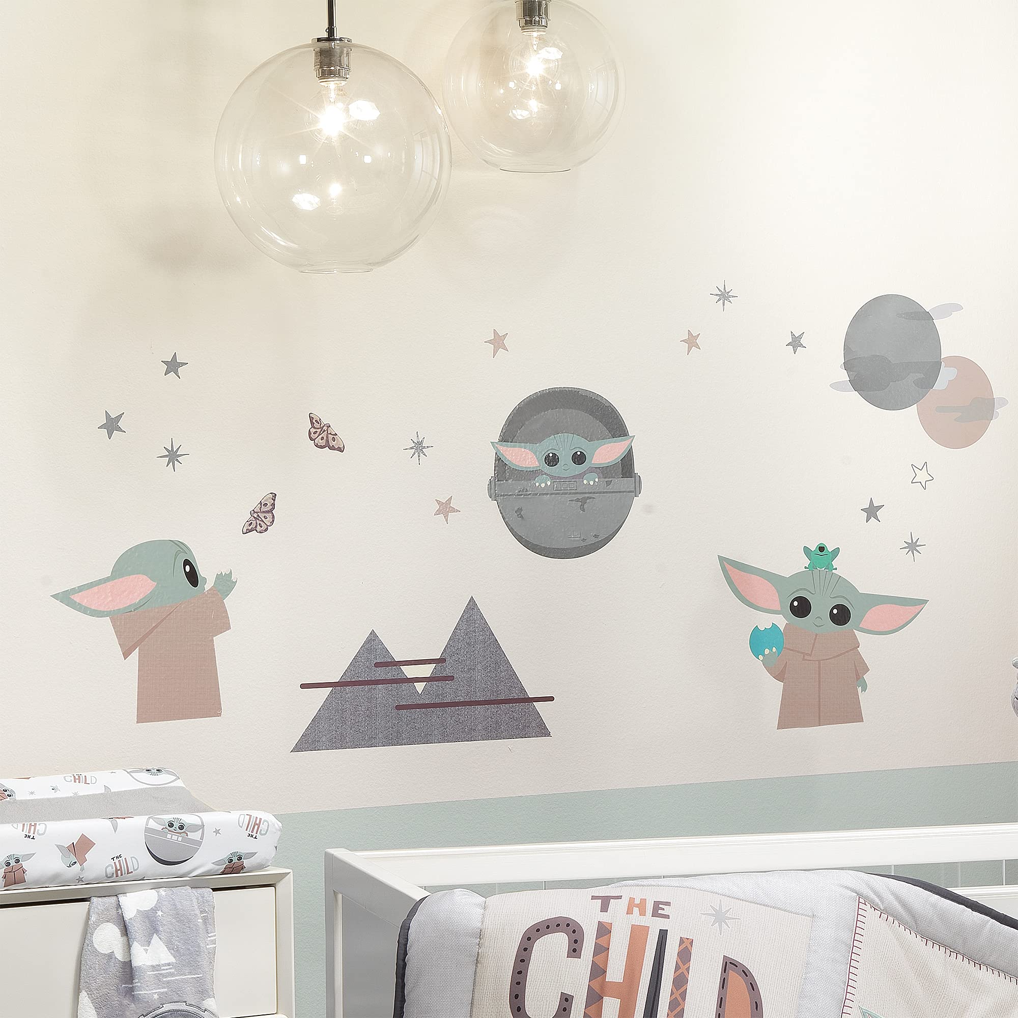 Lambs & Ivy mountains, stars and planets decals form a space-themed backdrop for imagination.