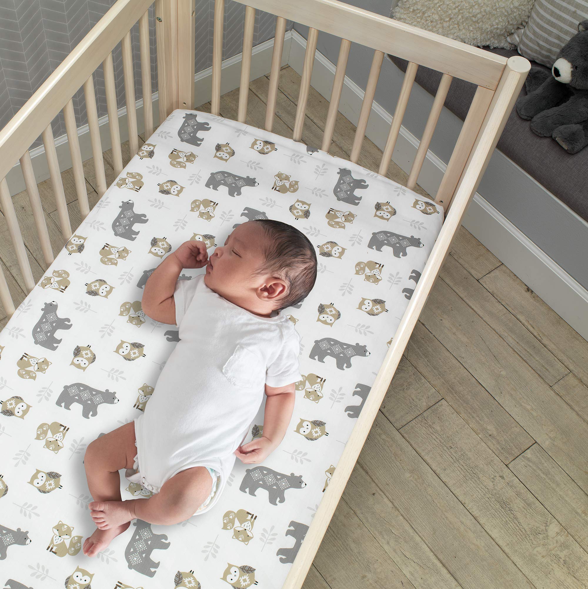 Lambs & Ivy Woodland Forest print highlights bears, owls, and foxes for a charming nursery theme.