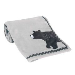 Lambs & Ivy Woodland Gray fleece blanket on a stroller for on-the-go comfort.