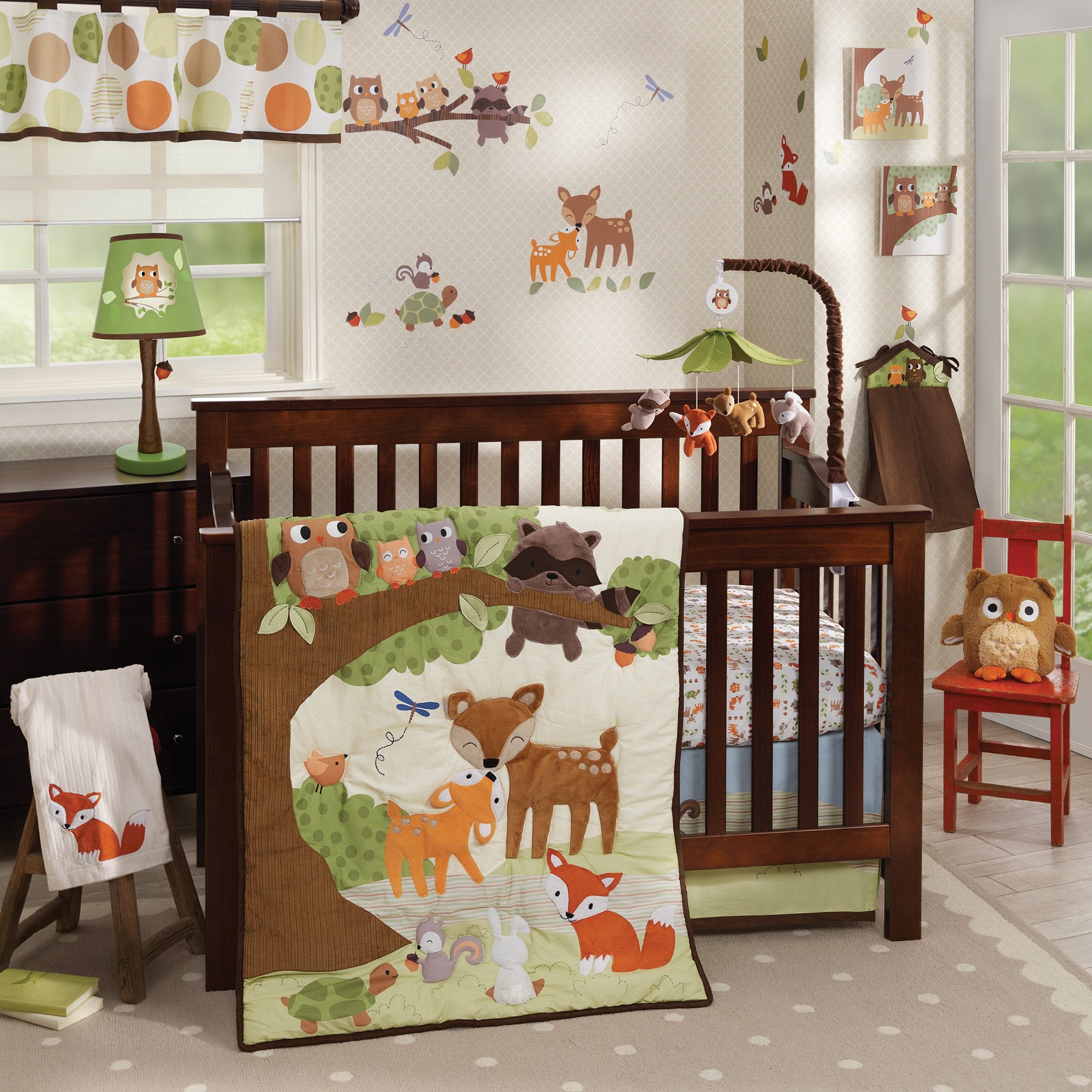 Lambs & Ivy Woodland Tales arm cover in brown coordinating with the mobile for crib safety and style.