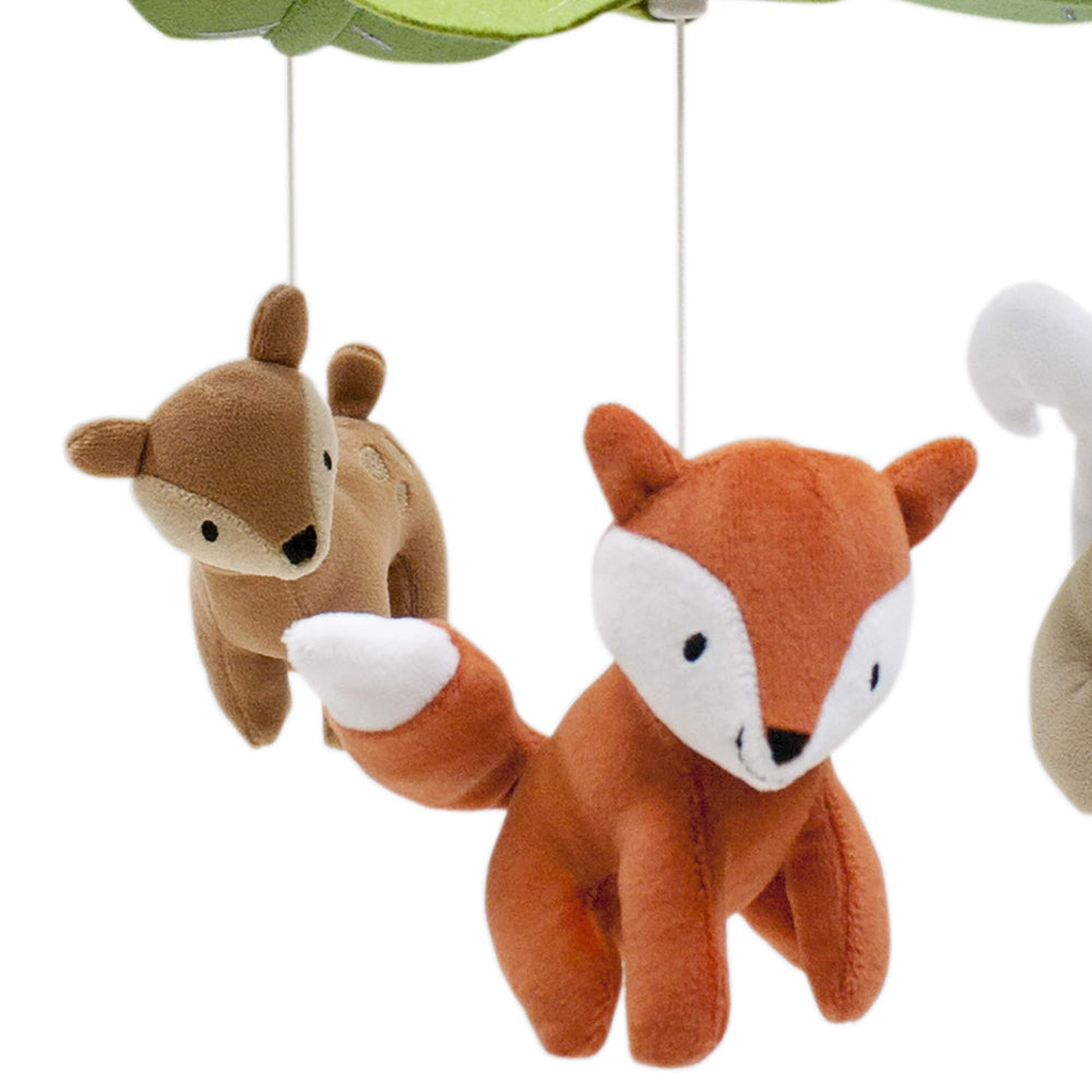 Lambs & Ivy Woodland Tales mobile near baby's crib playing Brahms' Lullaby for soothing sleep.