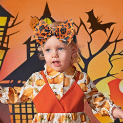 Lanmerry ghost-pattern bow for baby girl, secure elastic fit.