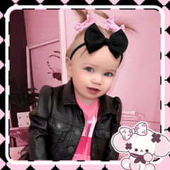 Lanmerry white baby bow headband on nylon band for gentle non-slip fit.