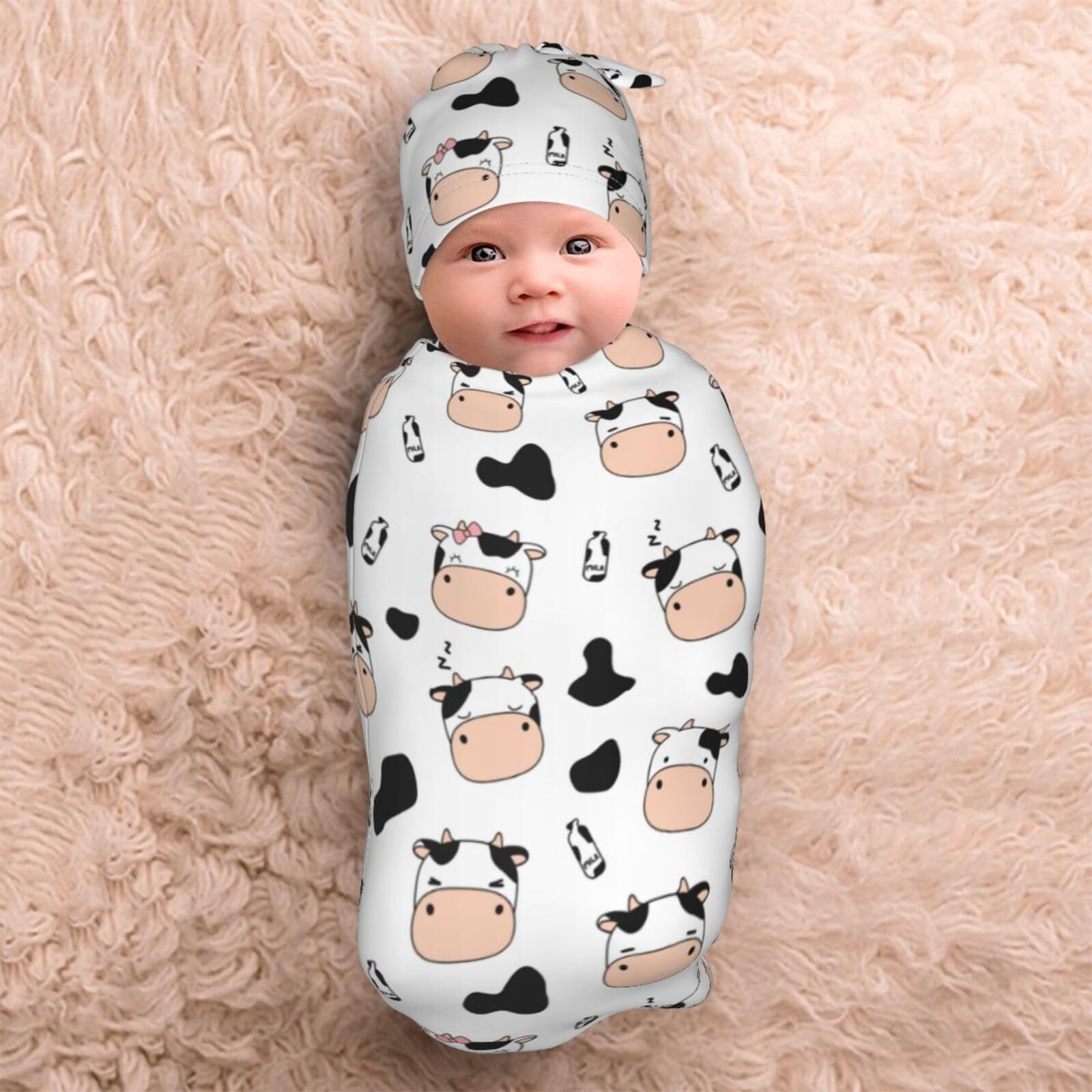 Lcokin newborn photography prop with cow-print swaddle ready for sessions.