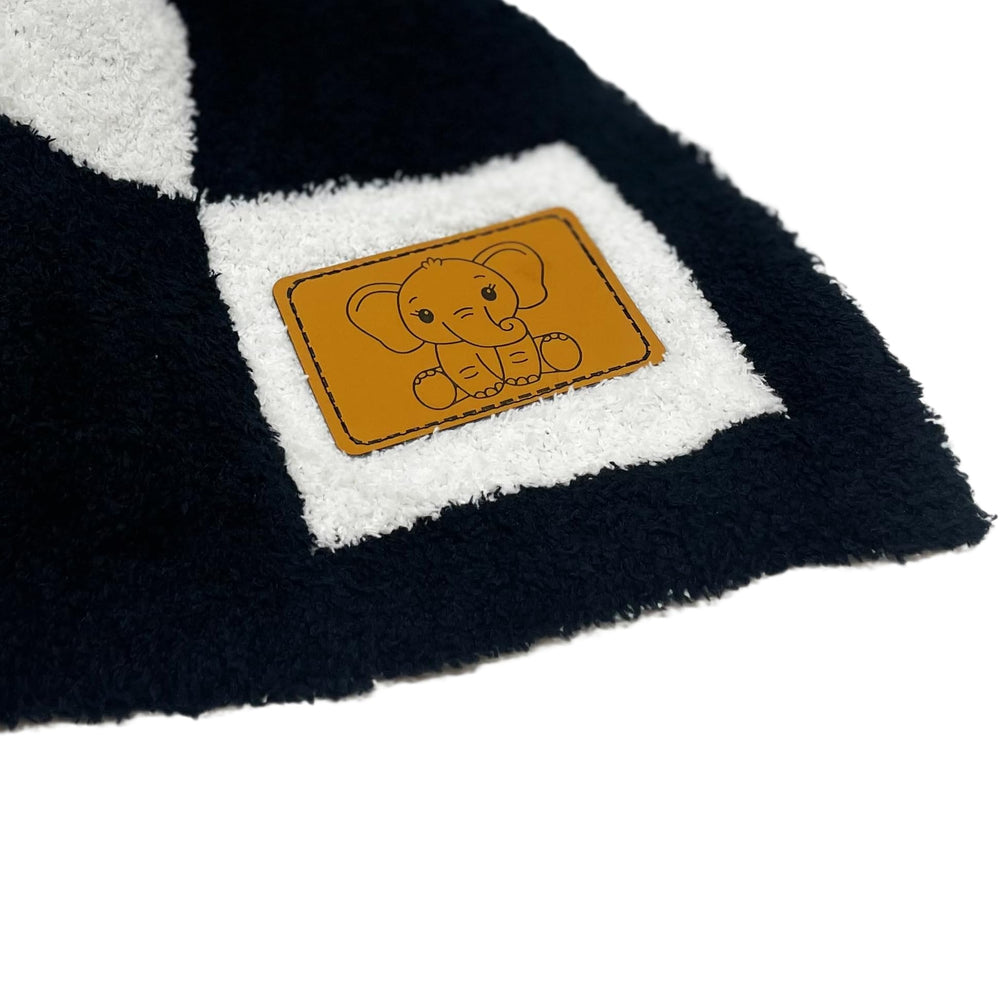 Leaps + Legends checkered blanket leather-patch detail adds durable branding