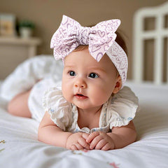 LemonSpace handmade baby bow heart print side view highlights flexible fit for growing heads.