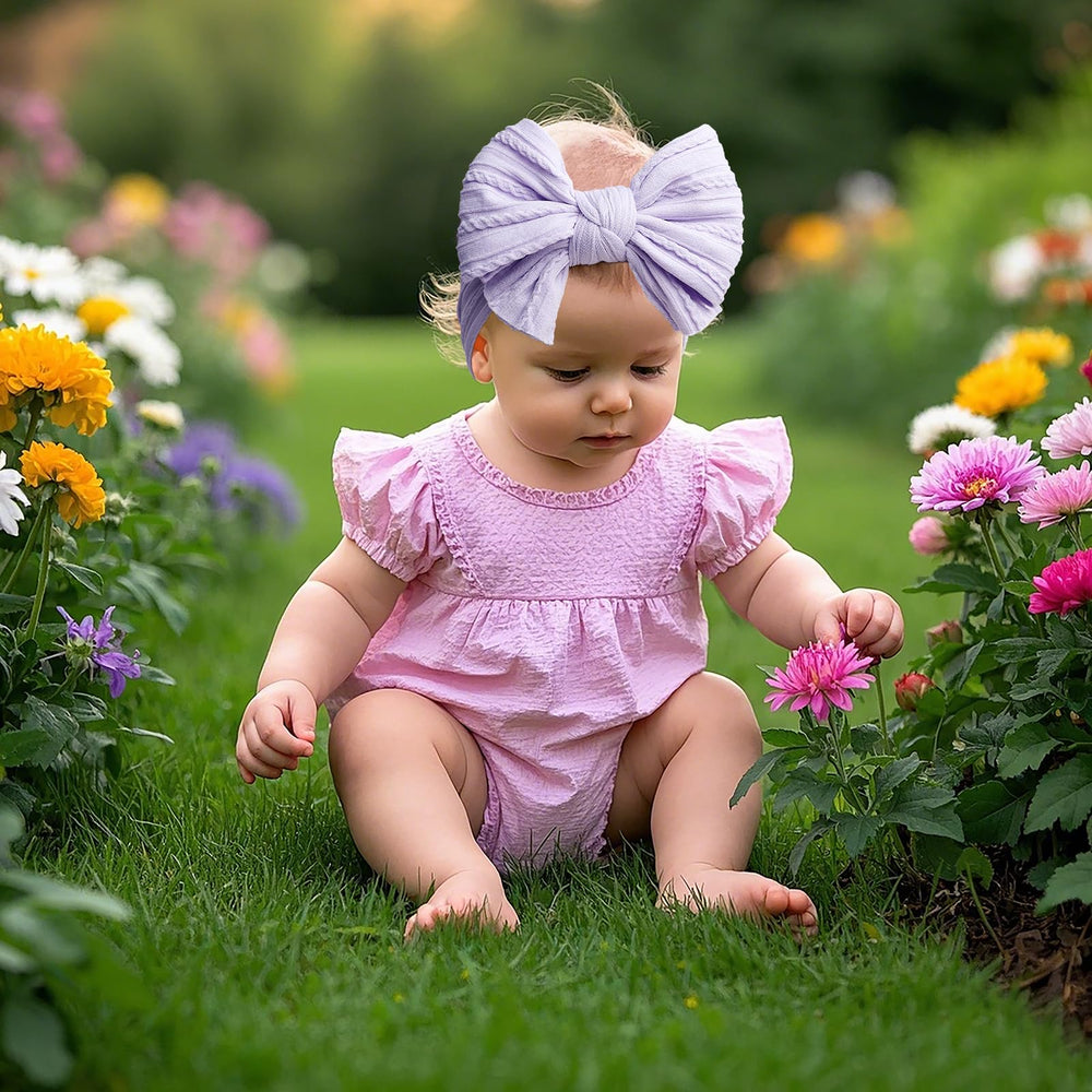 LemonSpace newborn headband fit demonstrates stretch and one-size design for growing babies.