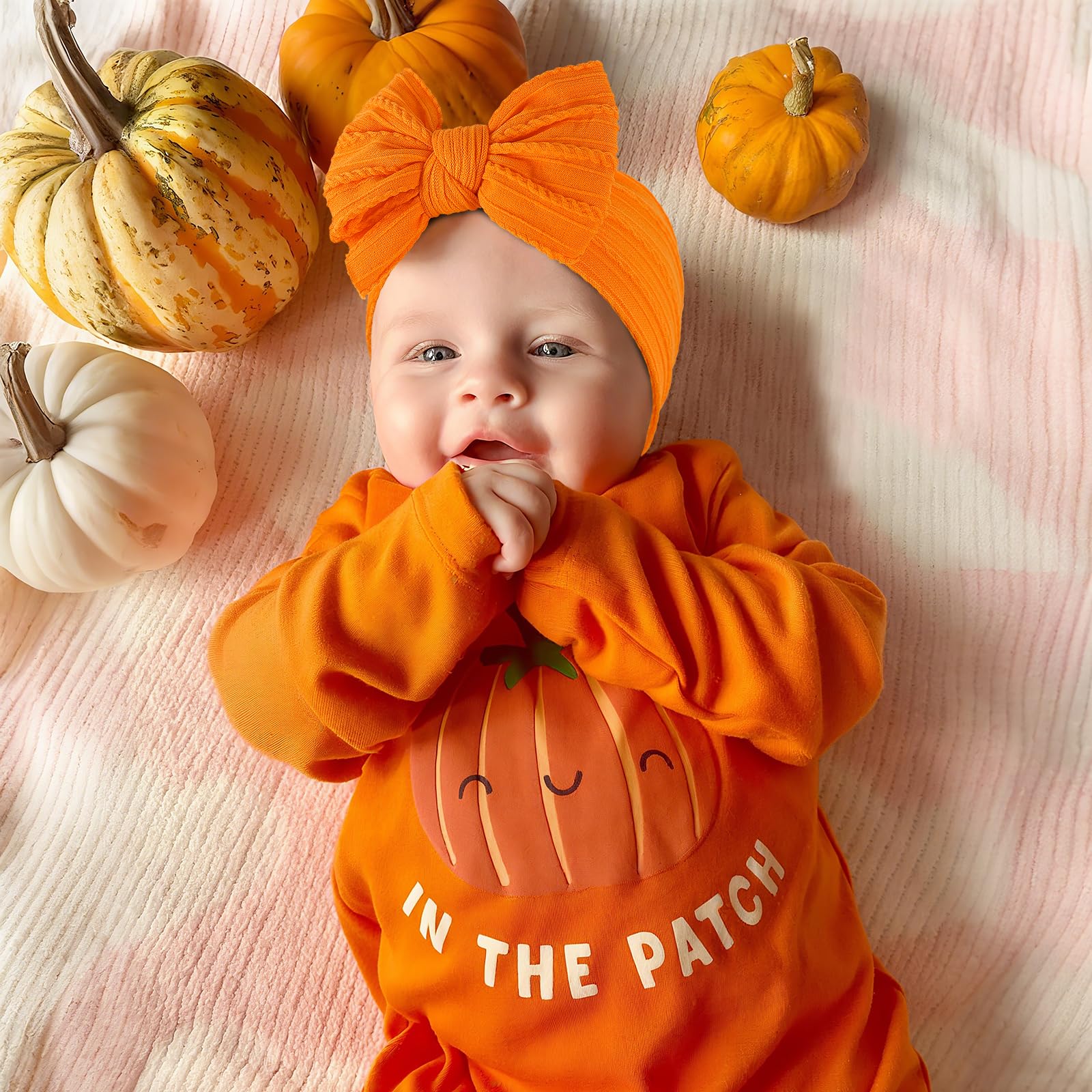 LemonSpace orange baby bow worn on a baby showing comfortable fit
