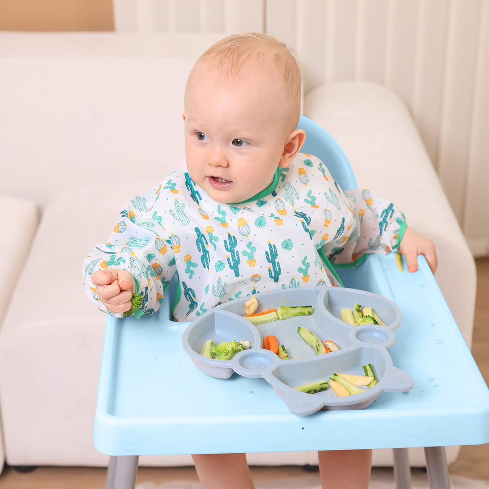 Lictin Green Whale bib helps hold crumbs away during snacks.