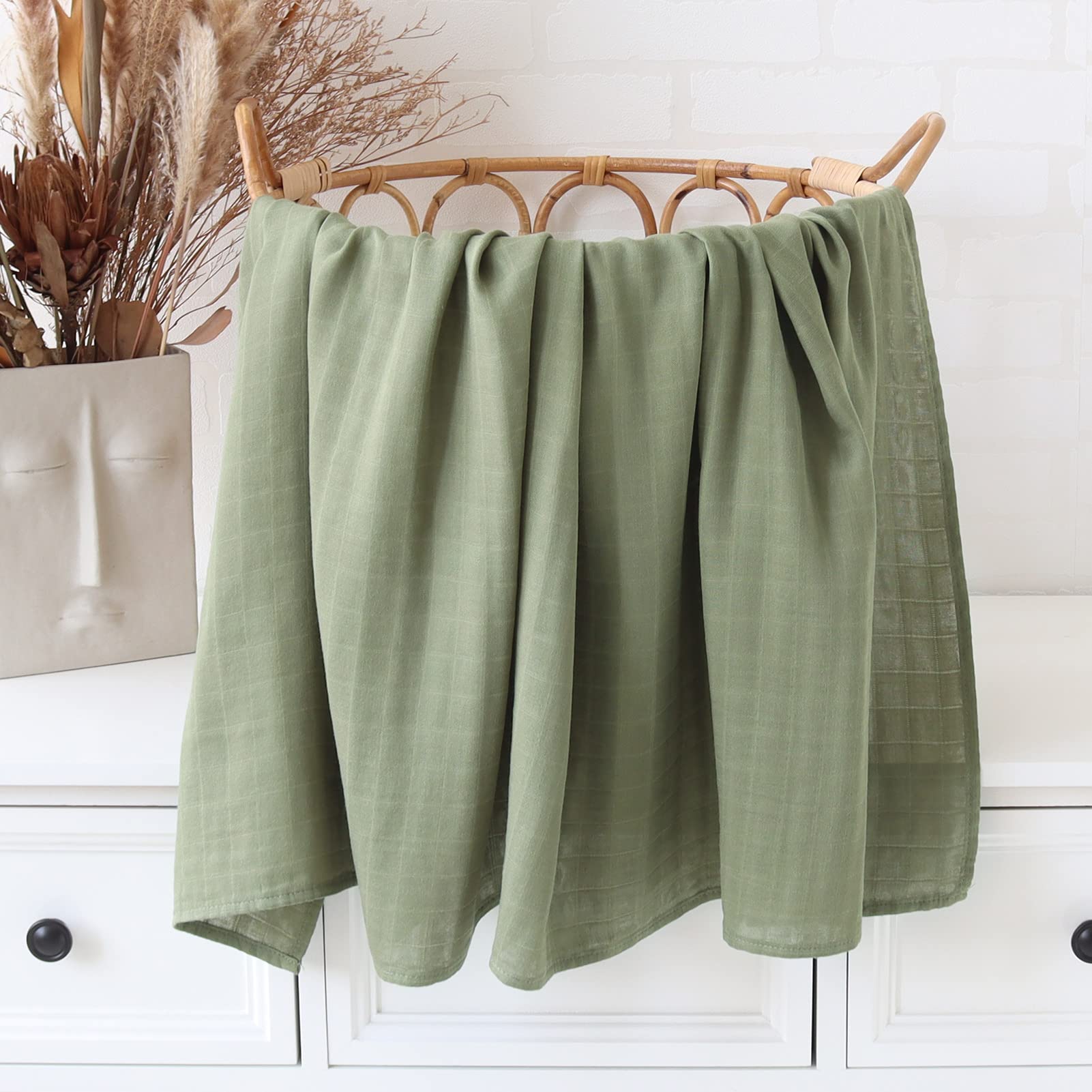 LifeTree olive-green swaddle on crib with calming nursery vibe.