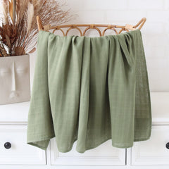 LifeTree olive-green swaddle on crib with calming nursery vibe.
