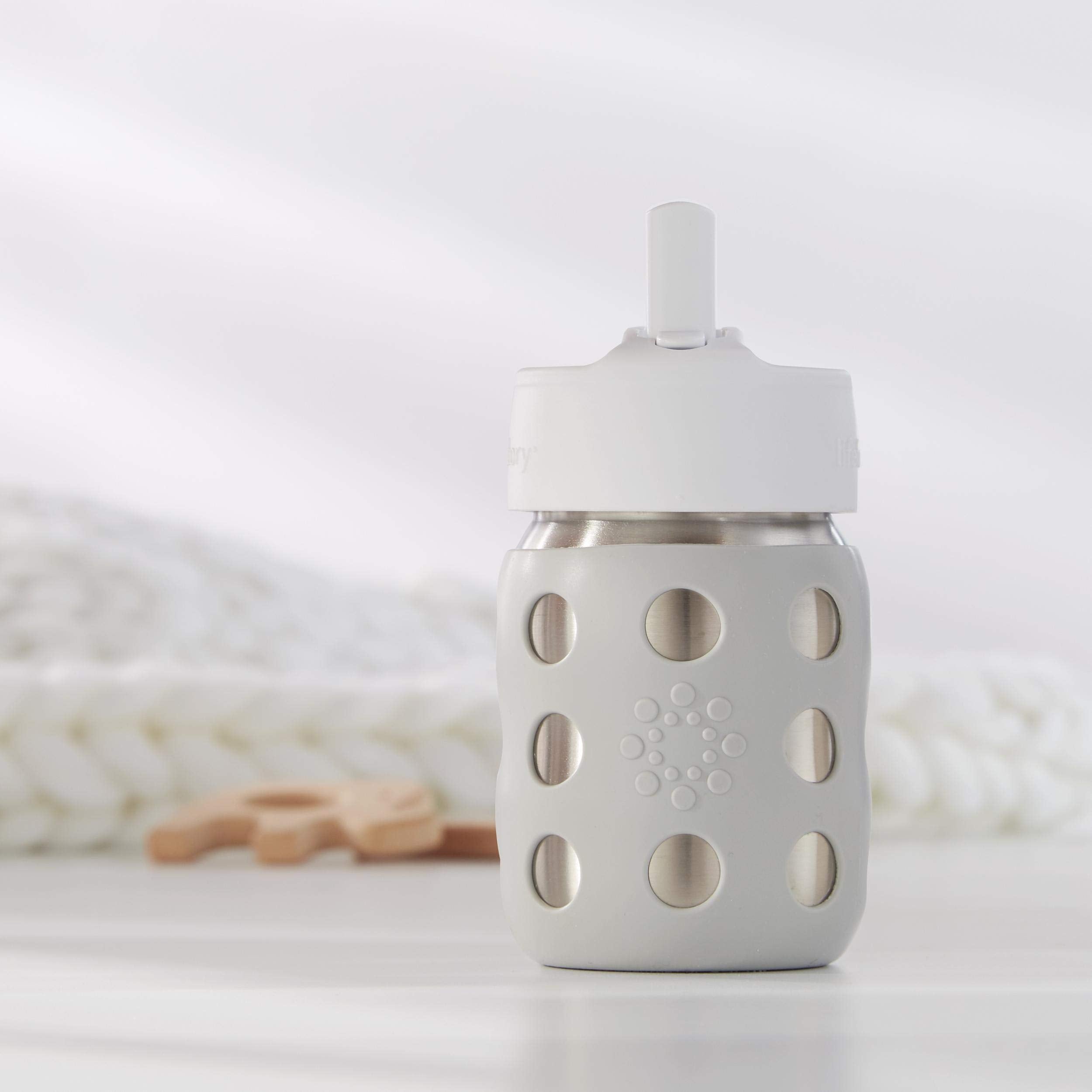 Lifefactory Pivot Straw Cap white shown with a bottle, ergonomic grip and kid-friendly sipping.